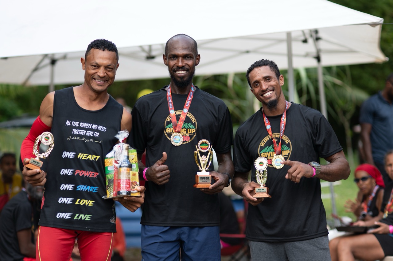 The top three men with their trophies and medals