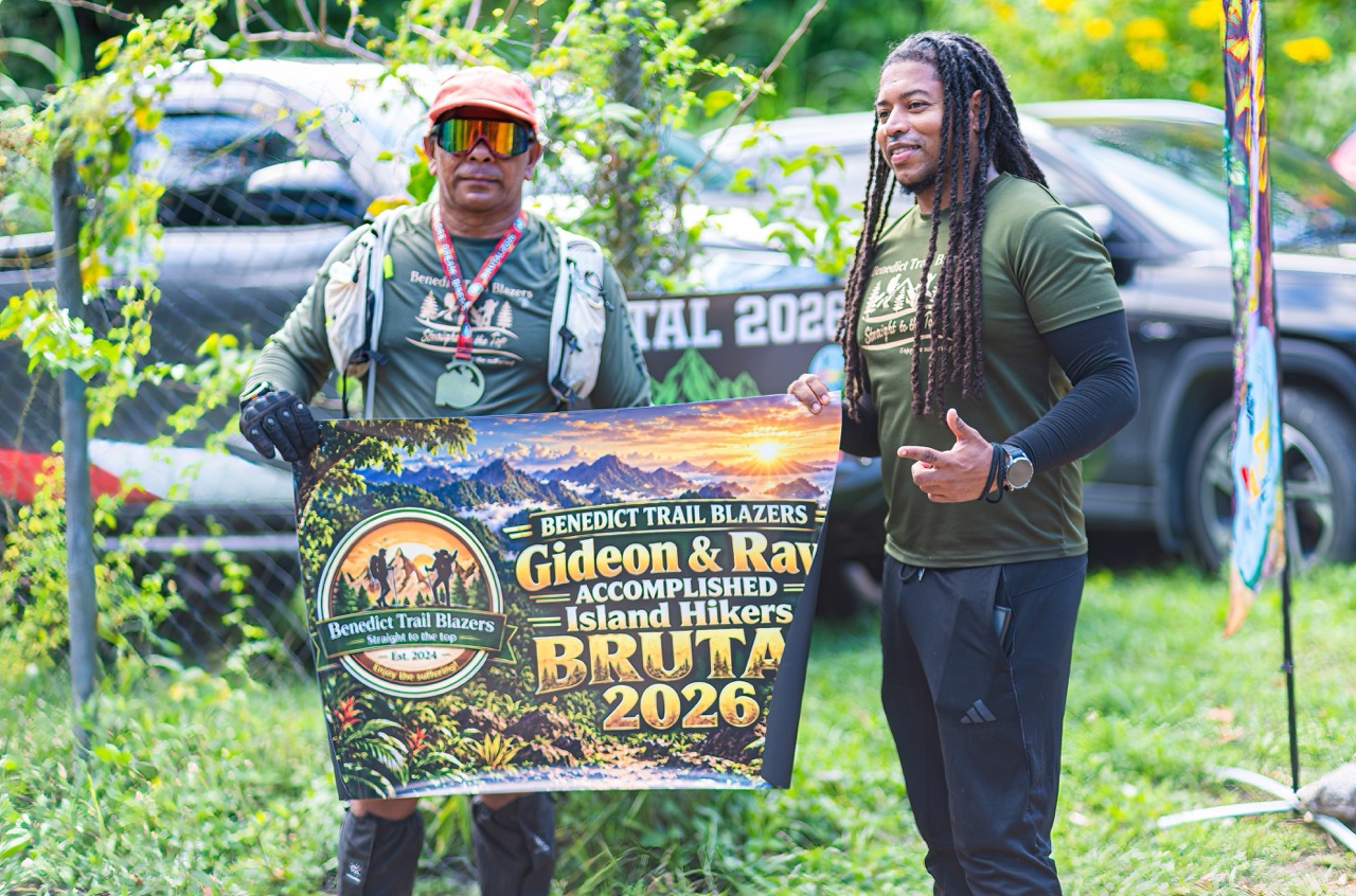 Two hikers with the Benedict Trail Blazers Brutal 2026 banner