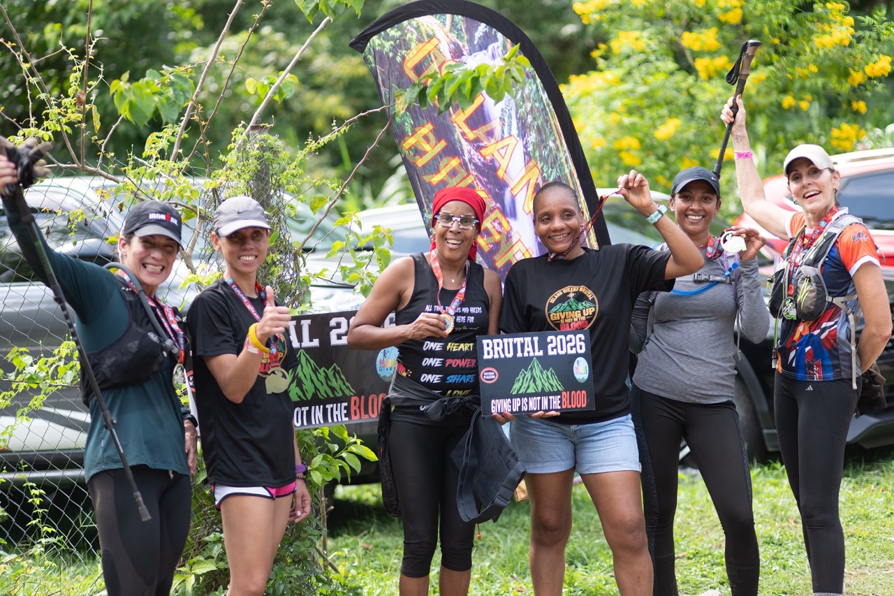 A group of women finishers celebrating with the Brutal 2026 sign