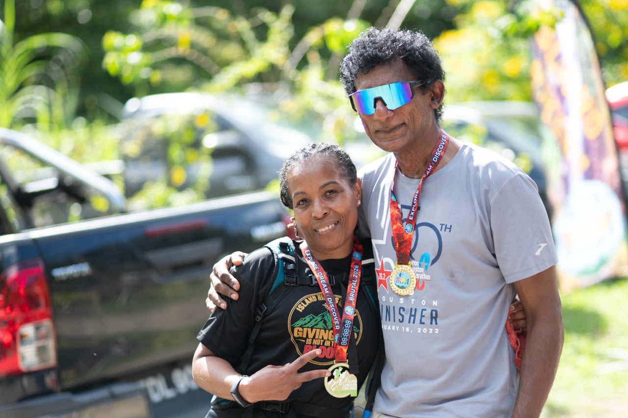 A couple of finishers smiling with their medals